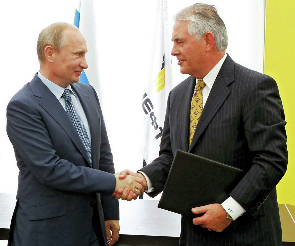 In this June 15, 2012 photo, Russian President Vladimir Putin, left, and ExxonMobil CEO Rex Tillerson shake hands at a signing ceremony of an agreement between state-controlled Russian oil company Rosneft and ExxonMobil at the Black Sea port of Tuapse, southern Russia. President-elect Donald Trump selected Tillerson to lead the State Department on Monday, Dec. 12, 2016.