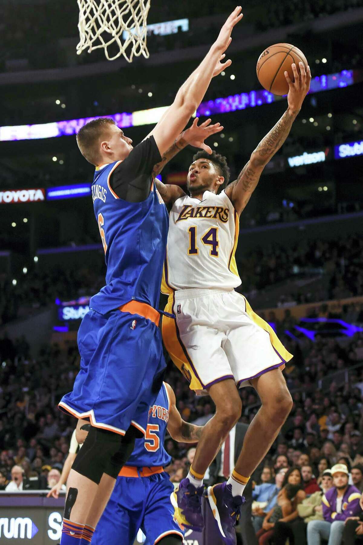 Los Angeles Lakers forward Brandon Ingram (14) battles New York Knicks forward Kristaps Porzingis (6), of Latvia, as he drives to the basket during the second half of an NBA basketball game on Sunday, Dec. 11, 2016 in Los Angeles. The Knicks win 118-112.