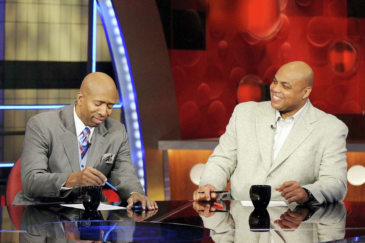 Basketball analysts Kenny Smith, left, and Charles Barkley are shown on the set at TNT studios in Atlanta. With eight years left on their deal to broadcast the NCAA Tournament, CBS and Turner are tacking on another eight. The extension announced Tuesday, April 12, 2016 goes all the way through 2032.