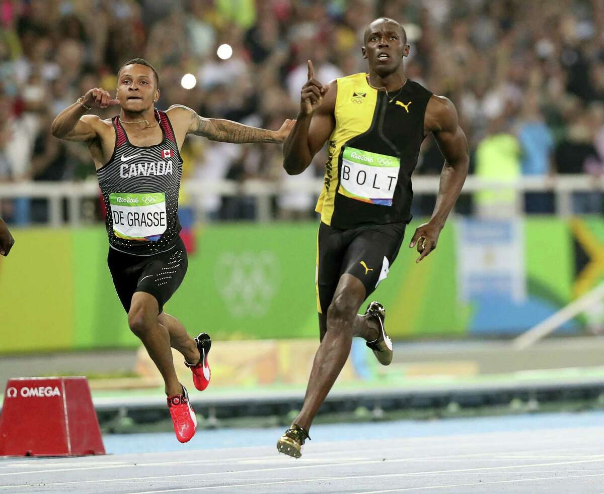 Jamaica’s Usain Bolt celebrates as he crosses the line to win gold in the men’s 100-meter final at the Olympic stadium in Rio de Janeiro on Sunday.