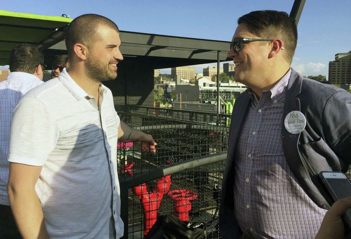 In this Sept. 22, 2016 photo, Denver marijuana consultant Kayvan Khalatbhari, left, chats with a lobbyist Joe Megysy at a fundraiser for marijuana policy reform in Denver. Business owners are replacing idealists in the pot-legalization movement as the nascent marijuana industry creates a donor base of entrepreneurs willing to spend to change drug policy.