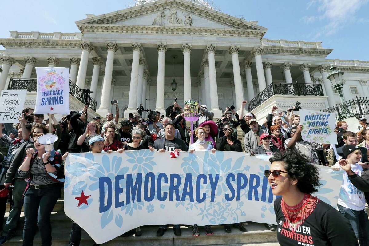 Alejandra Pablos of Arizona, lower right, leads a chant as voting rights reform demonstrators stage a sit-in at the Capitol in Washington, Monday, urging lawmakers to take money out of the political process. Locally, ConnPIRG and the League of Women Voters of Connecticut to talk about “people-powered solutions to the influence of big money in politics,” Wednesday at the Russell Library in Middletown.