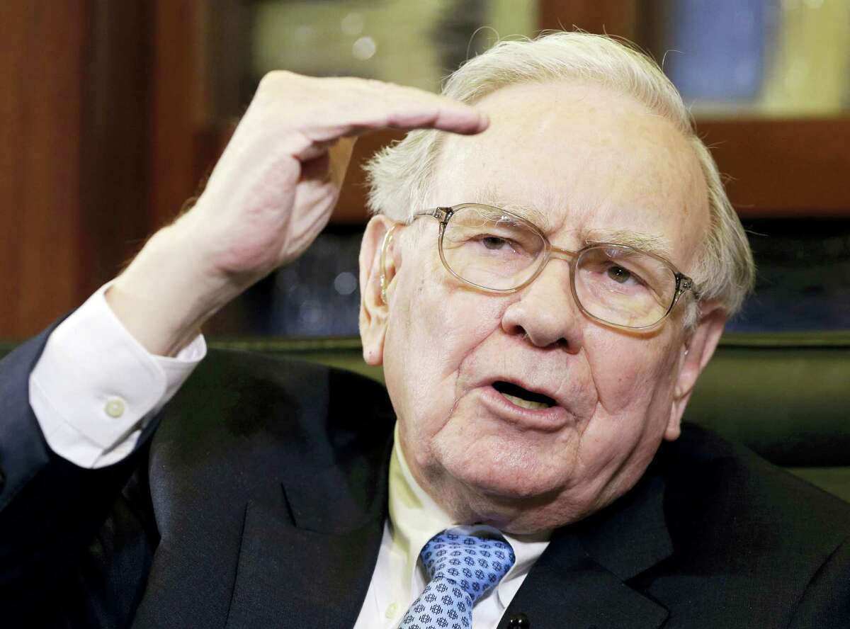 In this May 5, 2014 photo, Berkshire Hathaway Chairman and CEO Warren Buffett gestures during an interview with Liz Claman on the Fox Business Network in Omaha, Neb.