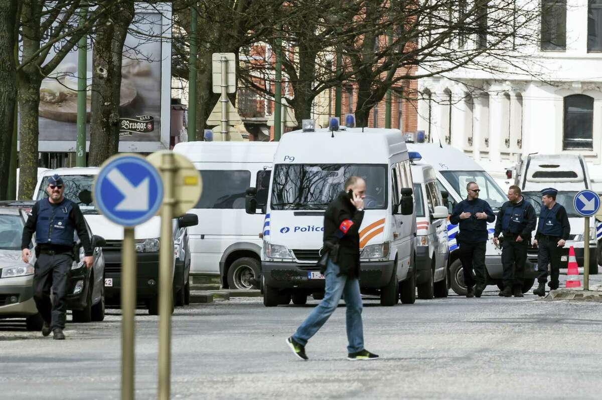Police secure an area during a house search in the Etterbeek neighborhood in Brussels on y April 9, 2016. The arrest Friday of six men suspected of links to the Brussels bombings, including the last known fugitive in last year’s Paris attacks, raised new questions about the extent of the Islamic State cell believed to have carried out the intertwined attacks that left 162 people dead in two countries.