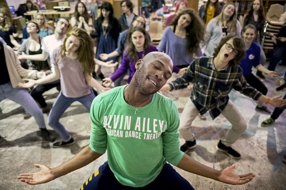 In this April 7, 2015 photo, dancer Antonio Douthit, front, of the Alvin Ailey American Dance Theater teaches a group of high school students a sampling of modern dance choreography during class at the site of the Lincoln Public Schools Arts and Humanities Focus Program, in Lincoln, Neb.