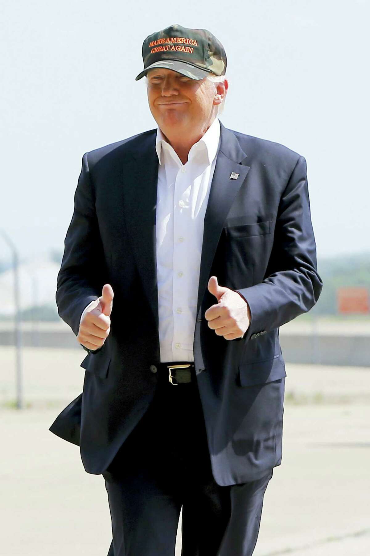 Republican presidential candidate Donald Trump gives a thumbs up as he arrives for a campaign rally Saturday at a private hanger at Greater Pittsburgh International Airport in Moon, Pennsylvania.