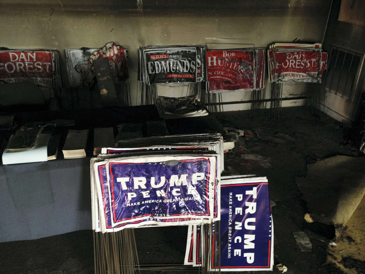 Melted campaign signs are seen at the Orange County Republican Headquarters in Hillsborough, NC on Oct. 16, 2016. Someone threw flammable liquid inside a bottle through a window overnight and someone spray-painted an anti-GOP slogan referring to “Nazi Republicans” on a nearby wall, authorities said Sunday. State GOP director Dallas Woodhouse said no one was injured.