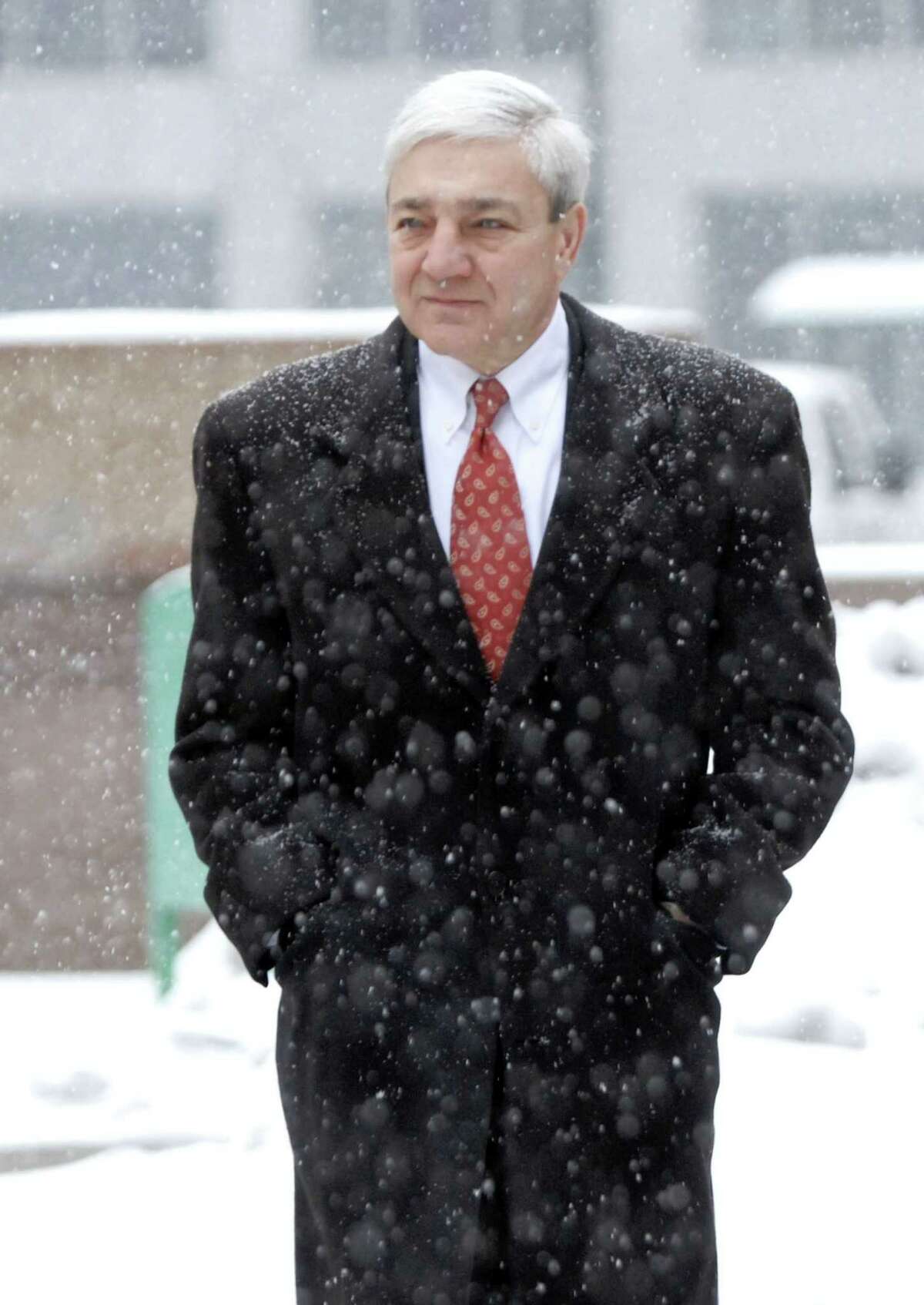 Former Penn State President Graham Spanier walks to the Dauphin County Court in a snow storm for a pretrial hearing in Harrisburg, Pa. on Tuesday, Dec. 17, 2013.