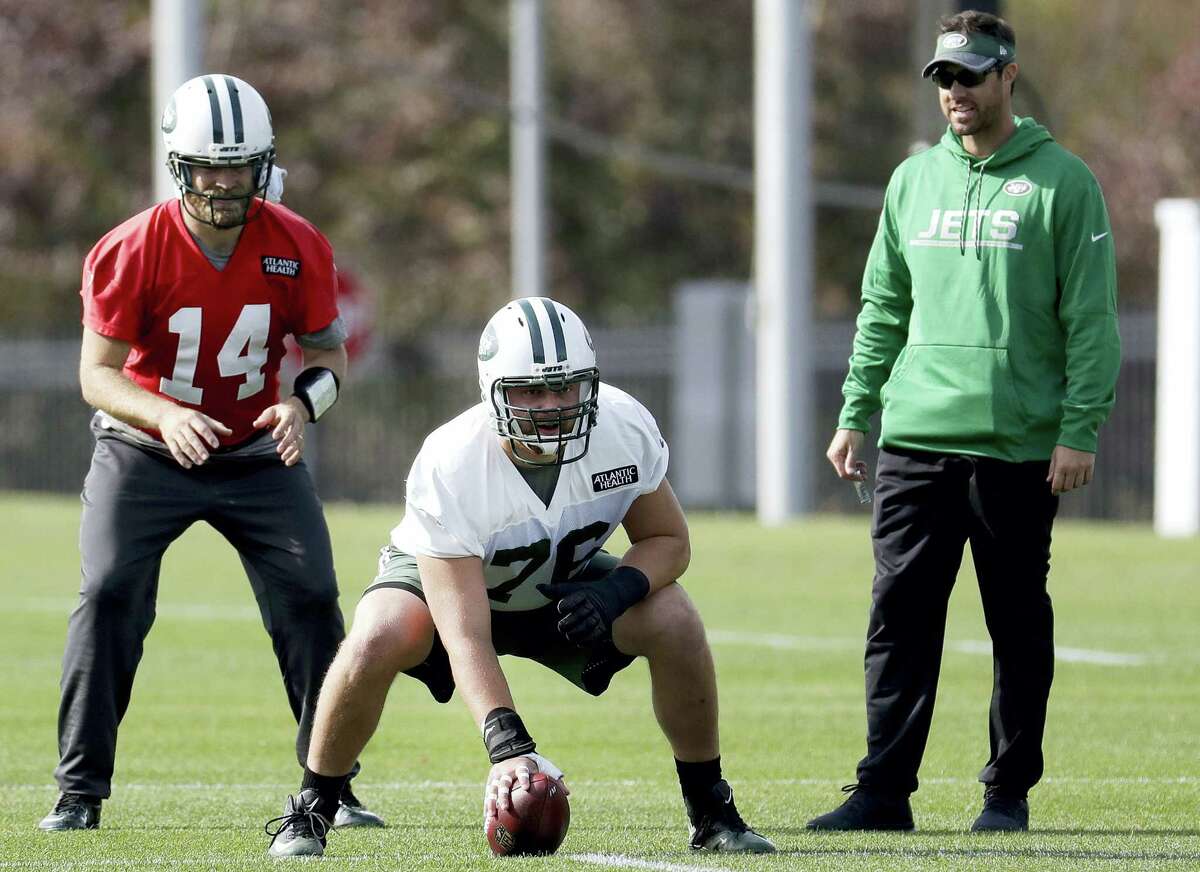 Ryan Fitzpatrick, left, prepares for the snap from center Wesley Johnson during a practice in Florham Park, N.J.