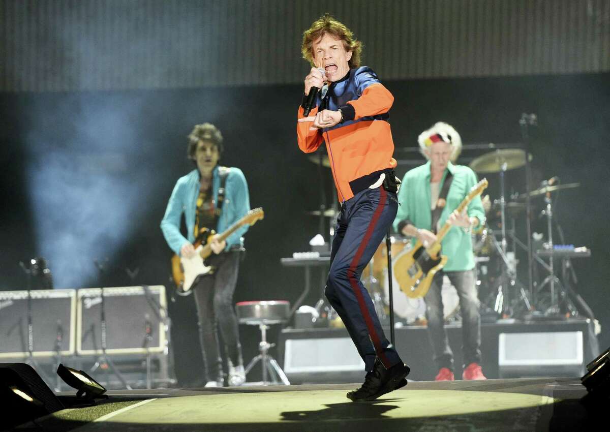 In this Oct. 7, 2016 photo, Mick Jagger, center, performs with Ron Wood, left, and Keith Richards of the Rolling Stones during their performance on day 1 of the 2016 Desert Trip music festival at Empire Polo Field in Indio, Calif. Jagger, the 73-year-old frontman of the Rolling Stones, was on hand Dec. 8, 2016 at a New York hospital when girlfriend, Melanie Hamrick, gave birth to the couple’s son.