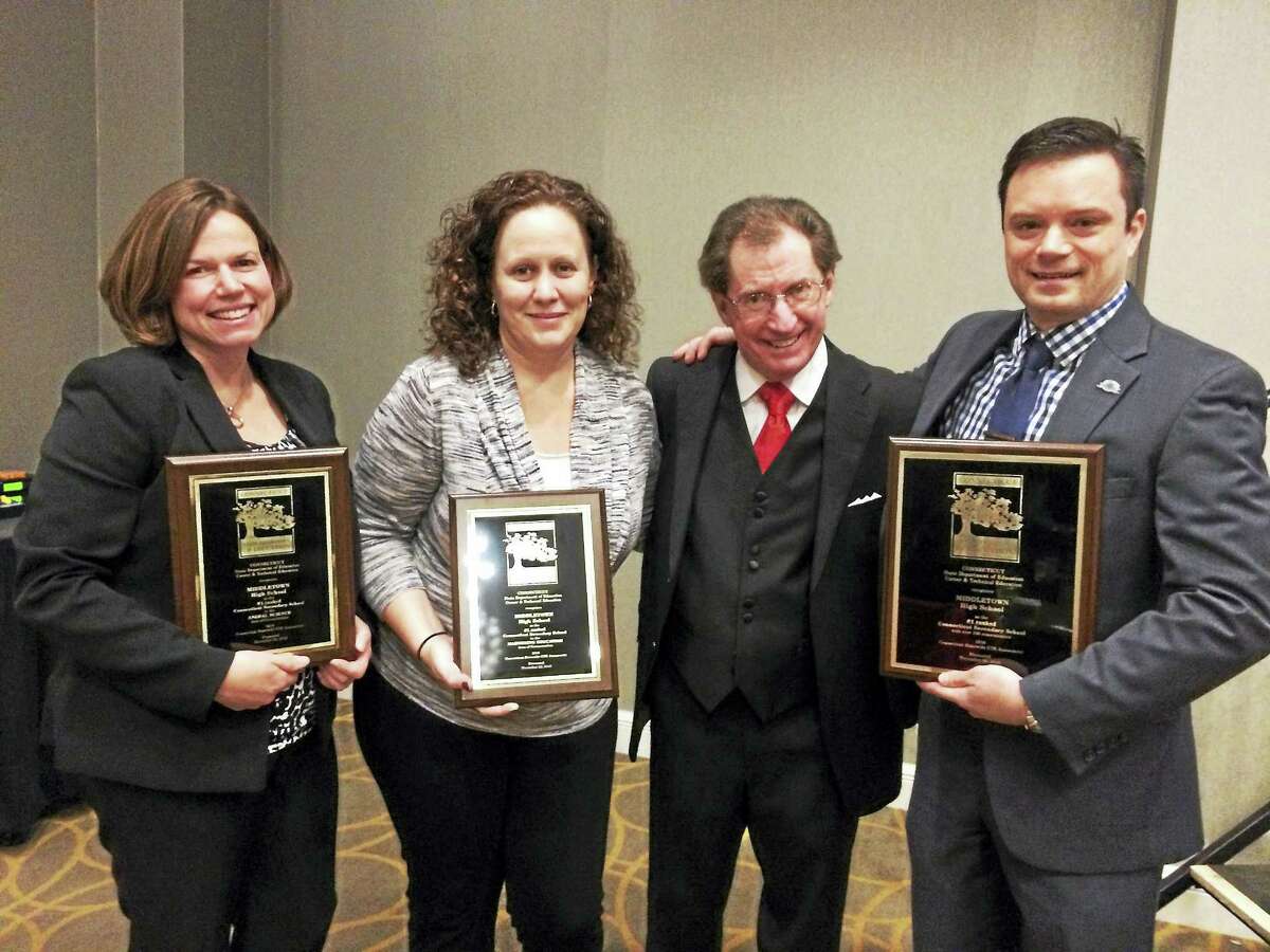 Middletown High School teachers, from lef, Amanda Thomson and Vivian Sheen, state Department of Education Stephen Hoag and Middletown High School teacher David Reynolds display the awards.