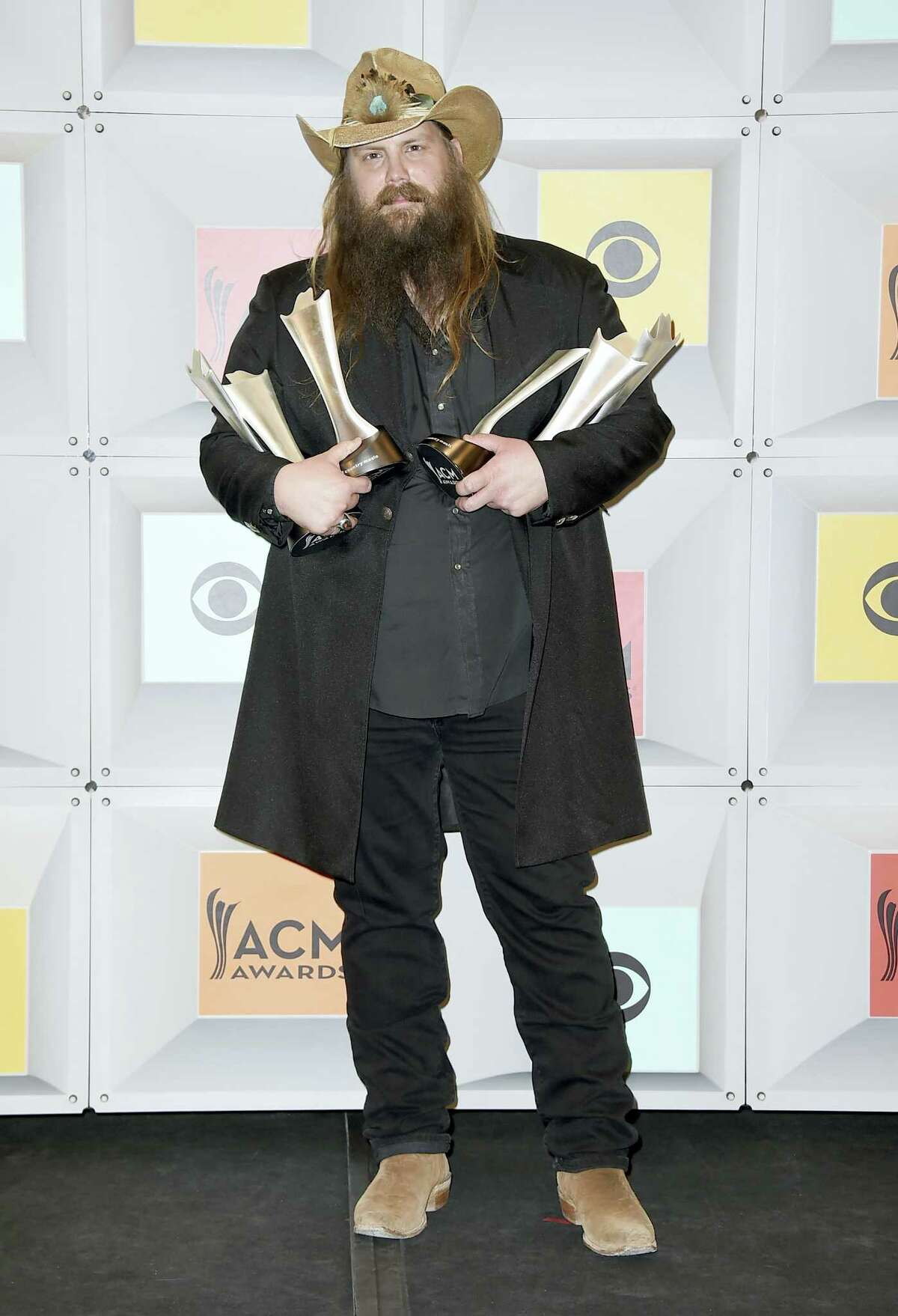 Chris Stapleton poses in the press room with the awards for album of the year for "Traveller", new male vocalist of the year, male vocalist of the year and song of the year for “Nobody to Blame”, at the 51st annual Academy of Country Music Awards at the MGM Grand Garden Arena on Sunday, April 3, 2016, in Las Vegas. (Photo by Jordan Strauss/Invision/AP)