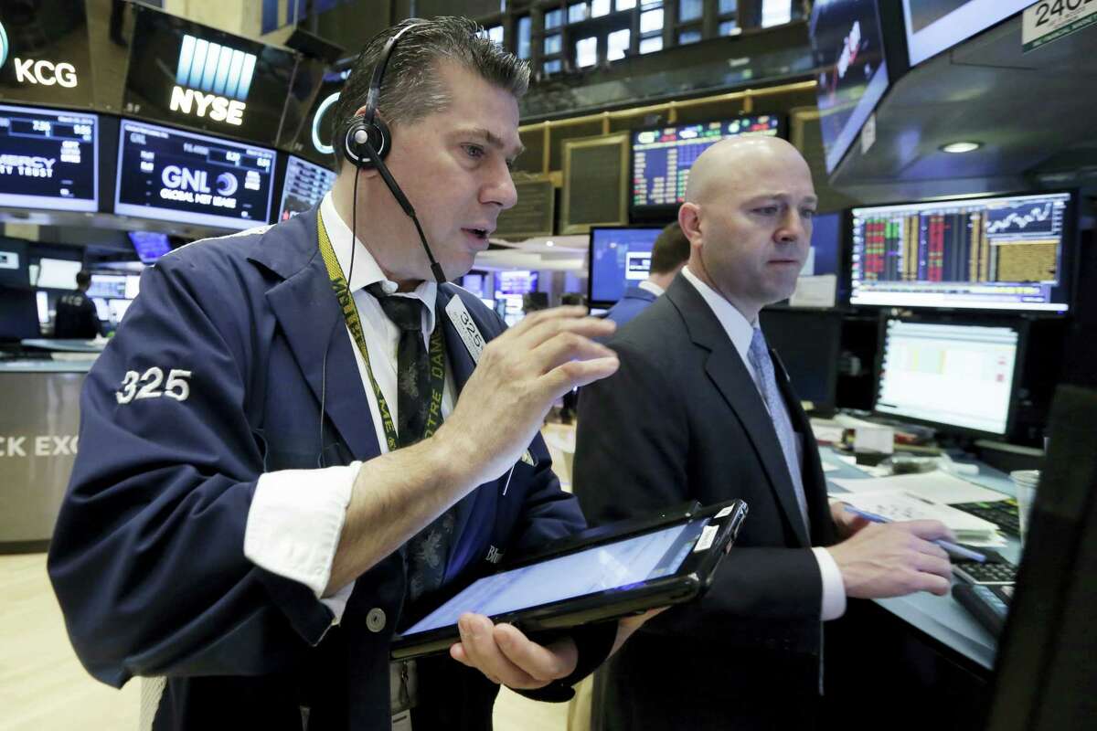 Trader William McInerney, left, and specialist Jay Woods work on the floor of the New York Stock Exchange recently.