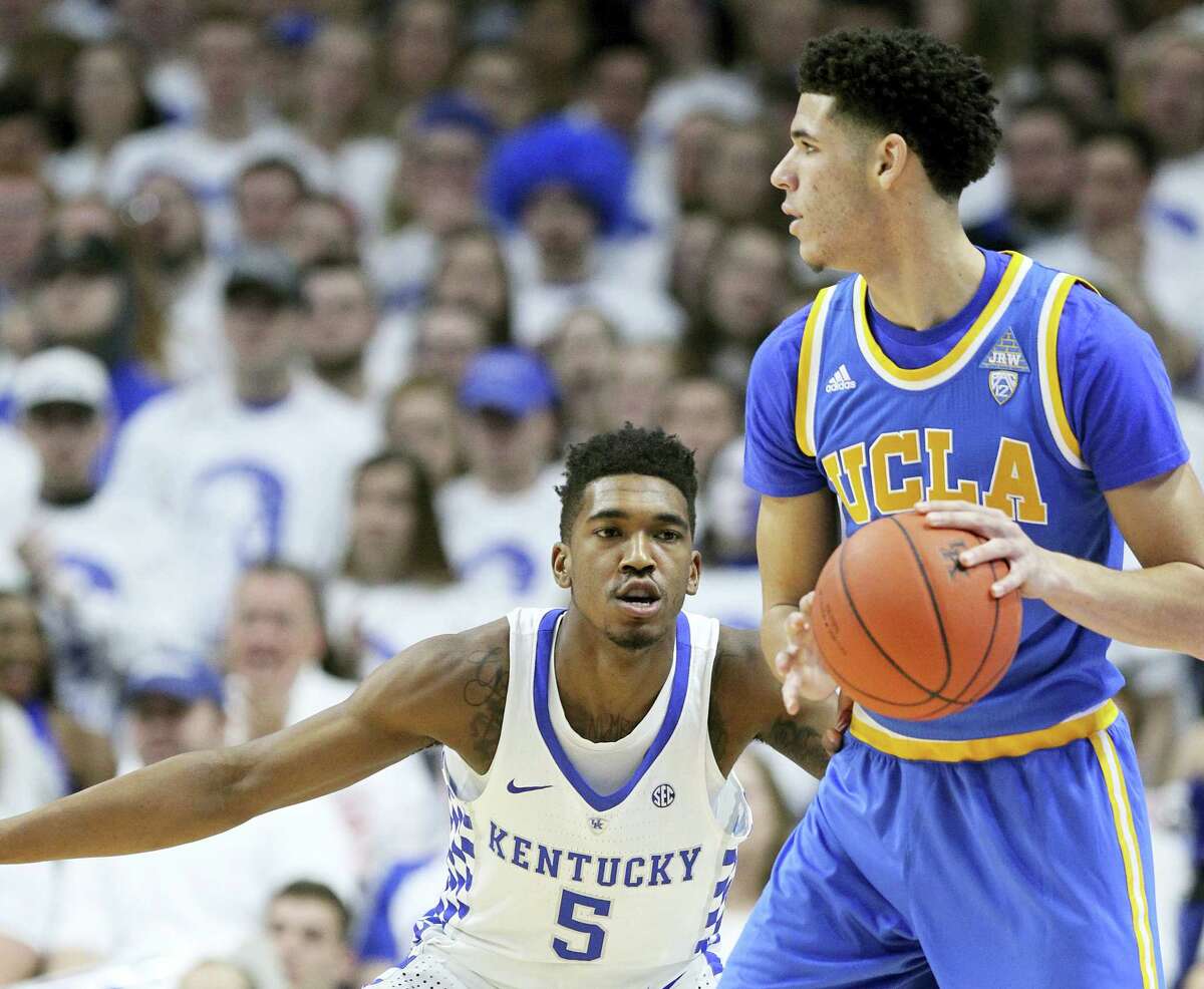 UCLA’s Lonzo Ball, right, looks for a teammate while guarded by Kentucky’s Malik Monk on Saturday.