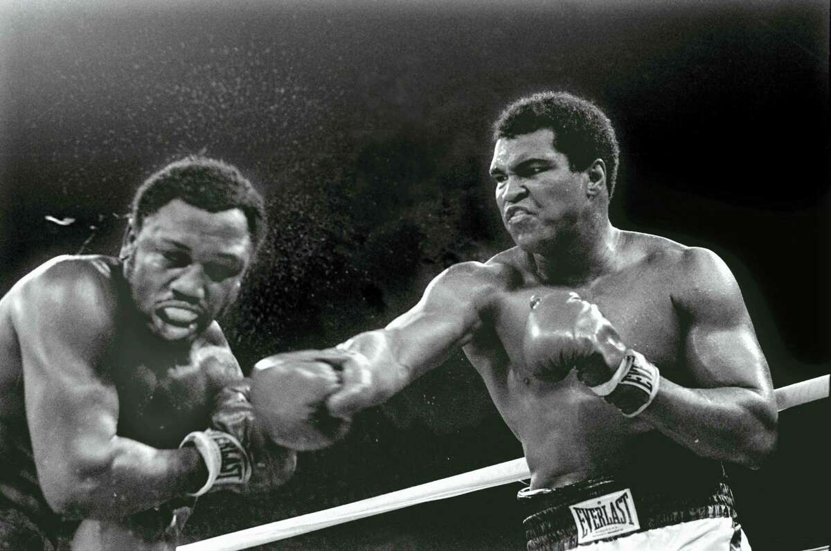 In this Oct. 1, 1975, file photo, Heavyweight champion Muhammad Ali connects with a right against challenger Joe Frazier in the ninth round of their title fight in Manila, Philippines. Ali won the fight on a decision to retain the title. Ali, the magnificent heavyweight champion whose fast fists and irrepressible personality transcended sports and captivated the world, has died according to a statement released by his family Friday, June 3, 2016. He was 74.