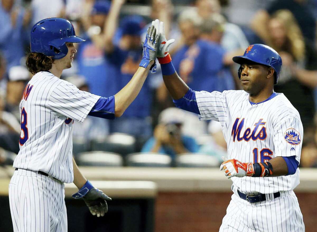 New York Mets Jacob deGrom, left, greets Alejandro De Aza after scoring on de Aza’s third-inning two-run home run Tuesday in New York. The Mets won 7-1.