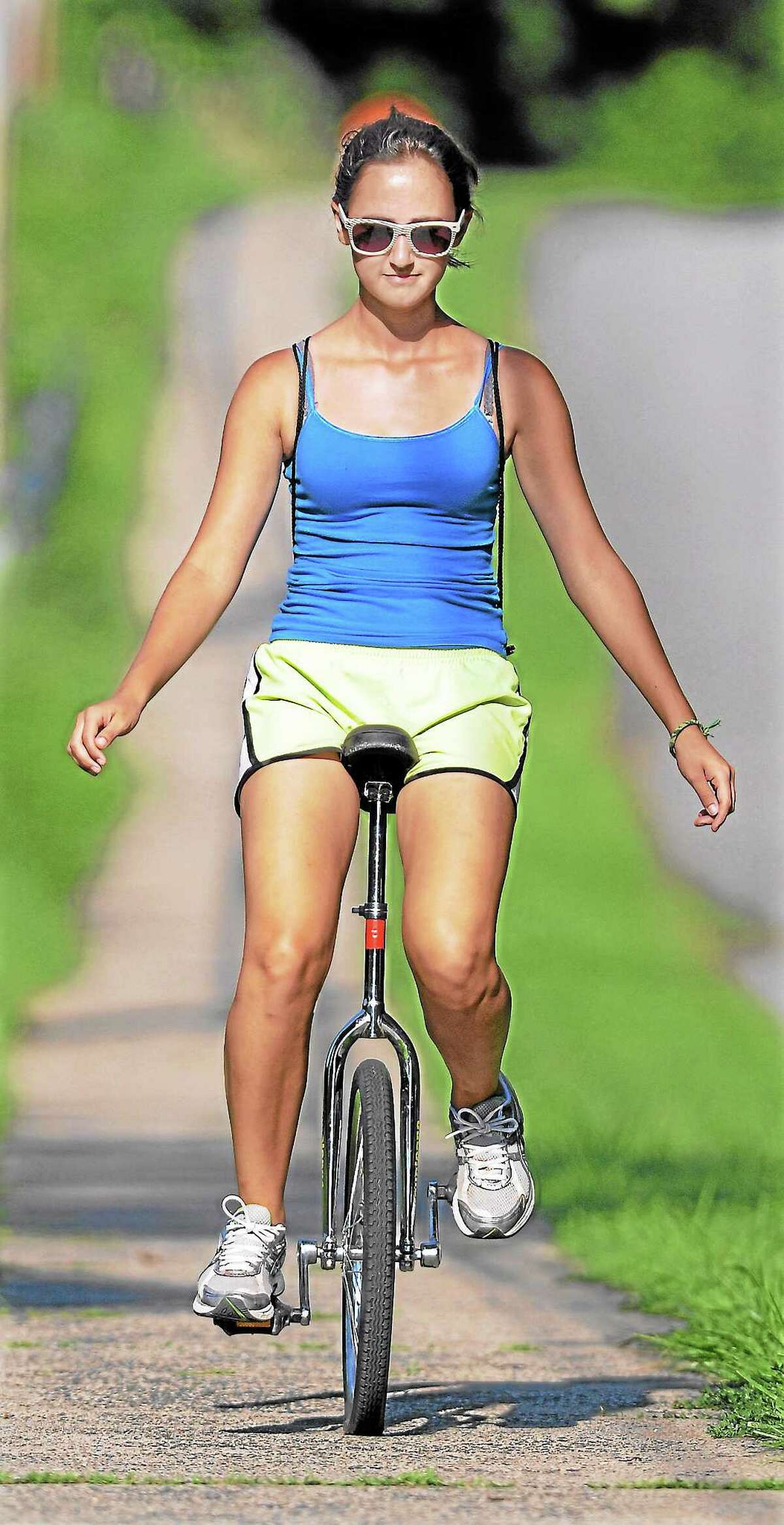 Eva Varszegi rides her unicycle down Wadsworth Street in Middletown.