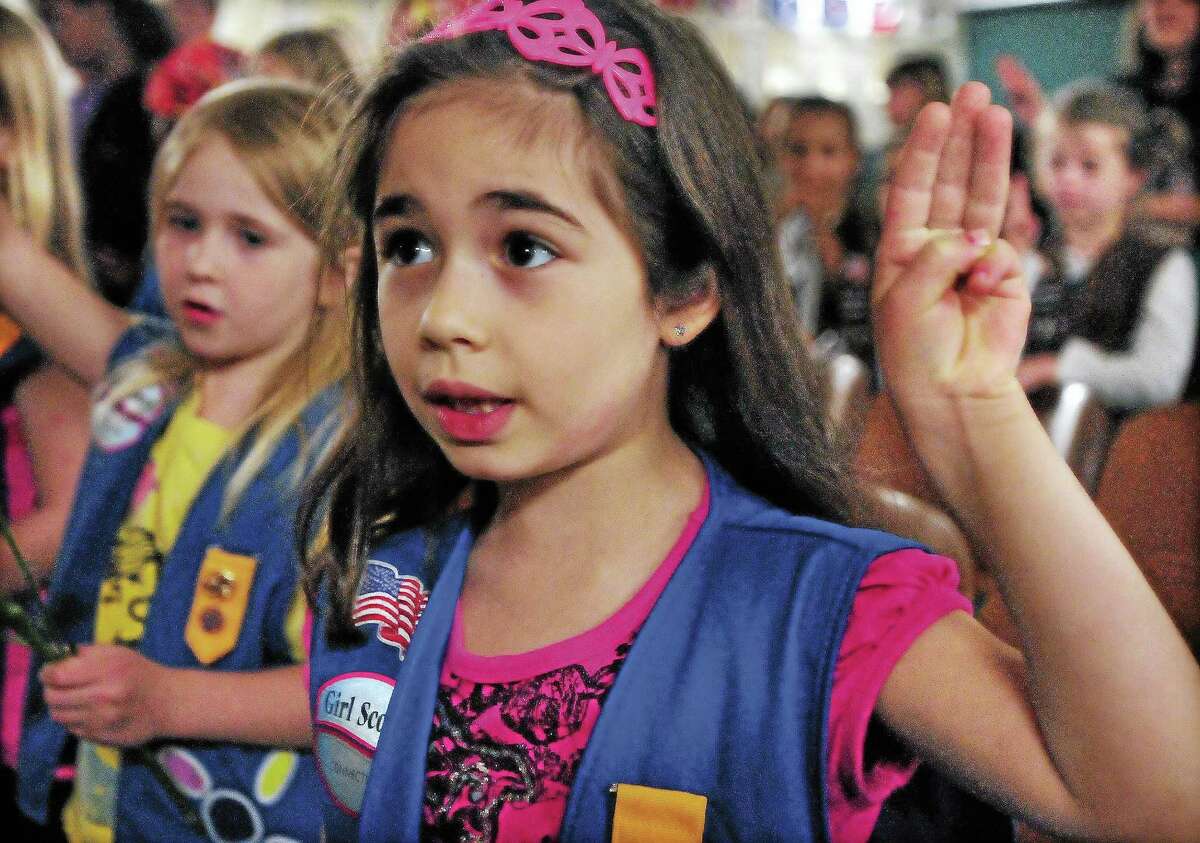 Daisy scout members of Troop 61108 say the Girl Scout Promise following a ceremony at Snow School in Middletown.
