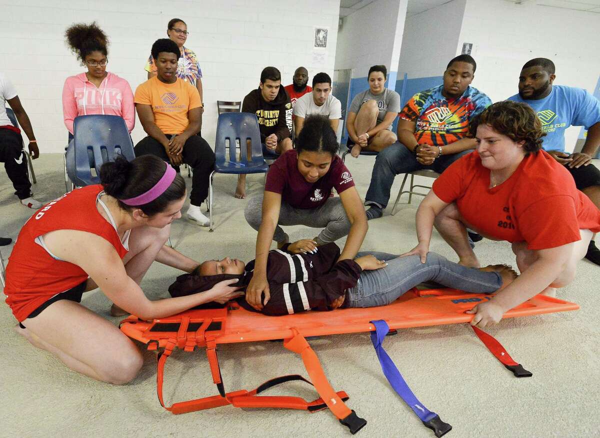 Camp counselors and life guards from the Boys and Girls Club of Stamford come together to talk about safety on the deck of the pool at the Yerwood Center on Tuesday, August 8, 2017 in Stamford, Connecticut. The safety class for staff is in response to the near-drowning that happen last week at Chelsea Piers.