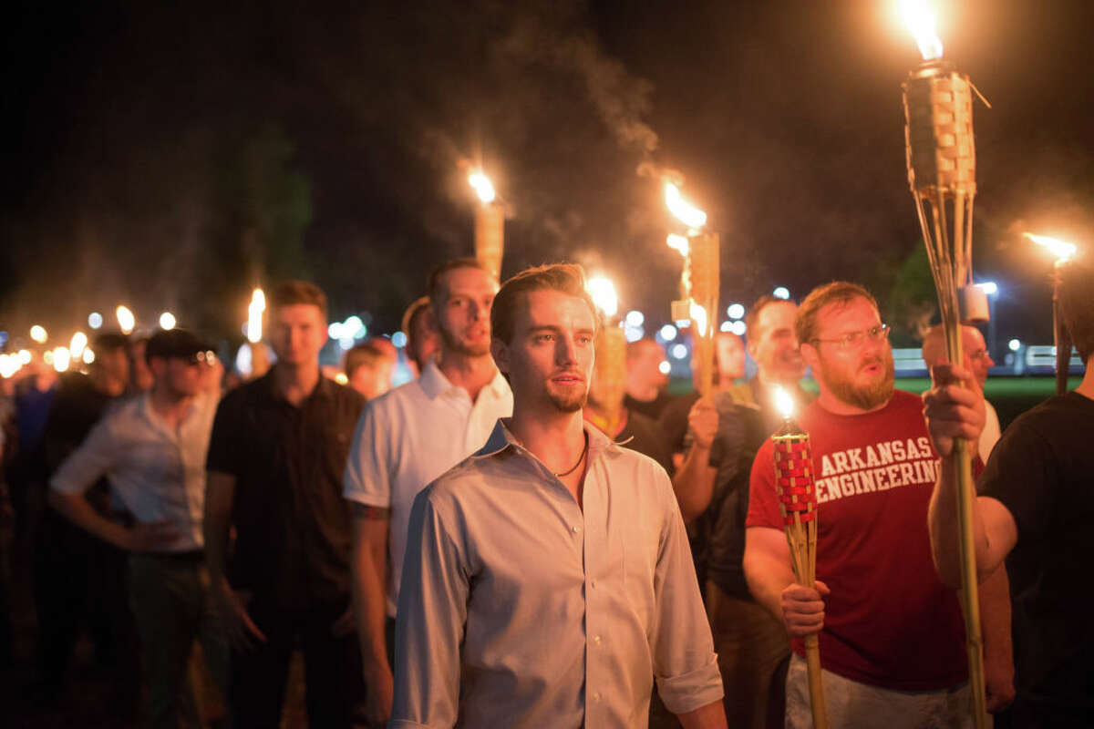Neo Nazis, Alt-Right, and White Supremacists take part a the night before the 'Unite the Right' rally in Charlottesville, VA, white supremacists march with tiki torchs through the University of Virginia campus. (Photo by Zach D Roberts/NurPhoto via Getty Images)