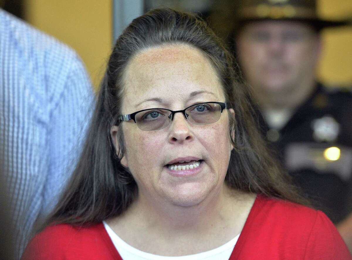 In this Sept. 14, 2015, file photo, Rowan County Clerk Kim Davis makes a statement to the media at the front door of the Rowan County Judicial Center in Morehead, Ky. Davis, who refused to issue marriage licenses to same-sex couples, says she met briefly with the pope during his historic visit to the United States. Vatican officials did not respond to an email asking for comment early Wednesday, Sept. 30.