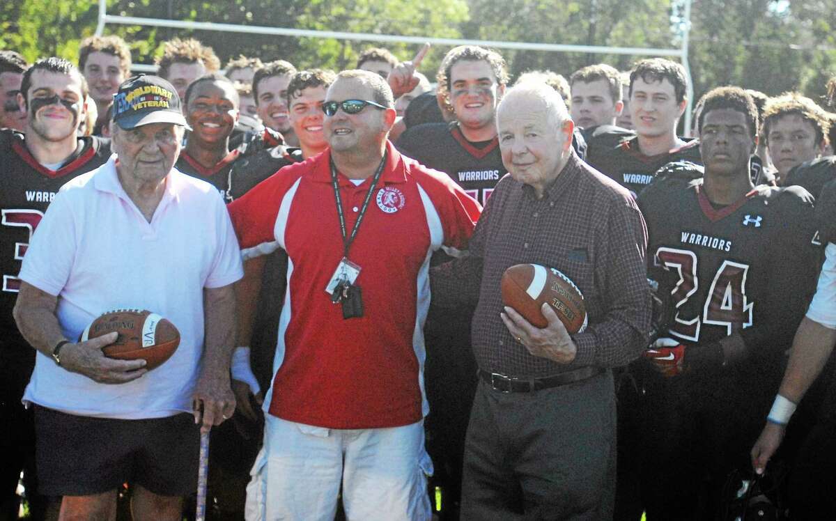 Valley Regional/Old Lyme head coach Tim King, center, with his father, George C. King, left, and his uncle, Tim Keenan following the Warriors 42-7 win over Old Saybrook/Westbrook on Saturday at Old Lyme High School. King and Keenan, who were awarded game balls, were members of the 1941 Old Lyme football team.