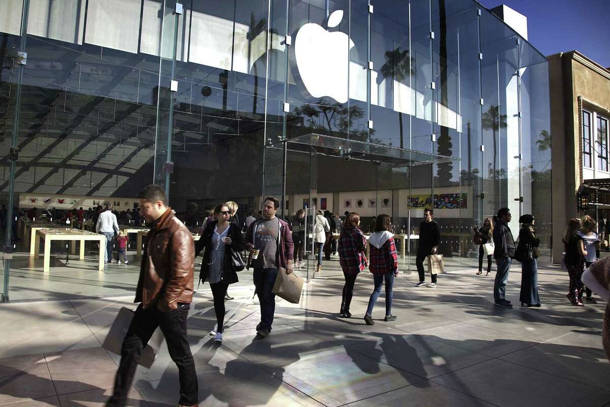 In this Jan. 3 photo, shoppers walk by the Apple Store along the the Third Street Promenade in Santa Monica, Calif.
