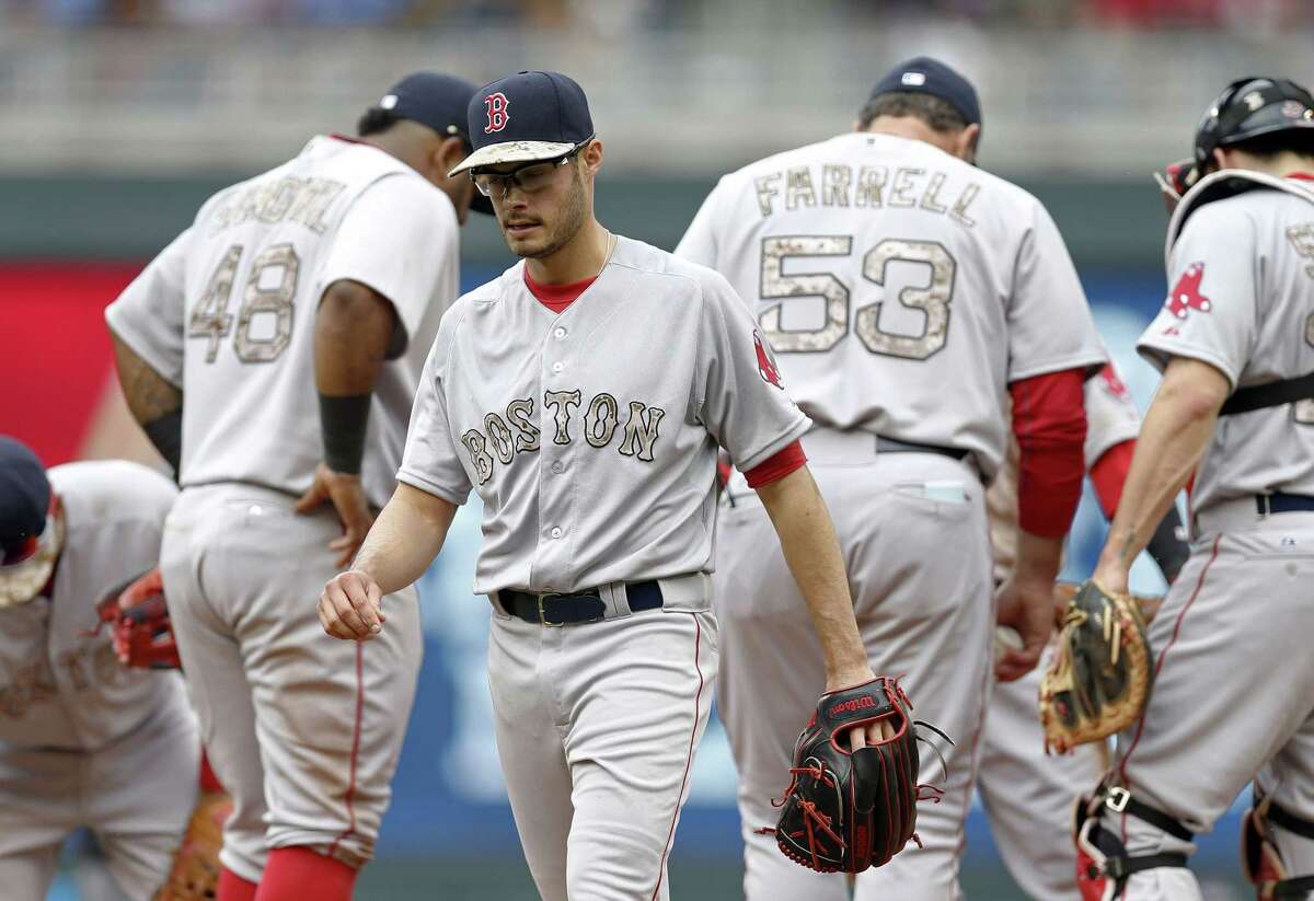 Boston Red Sox pitcher Joe Kelly leaves in the second inning of Monday’s game after giving up seven runs to the Minnesota Twins in Minneapolis.