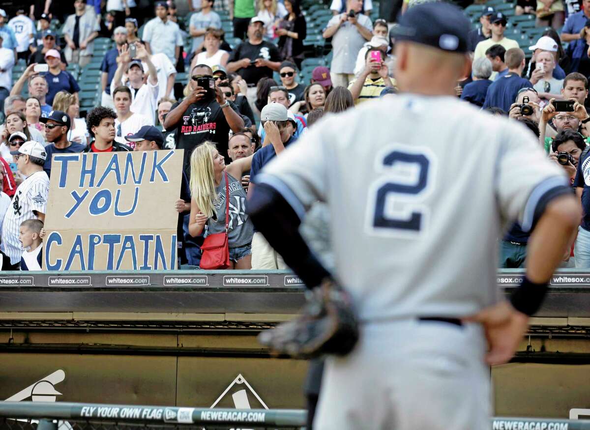 Yankees fans hold a sign for Derek Jeter after the Yankees defeated the White Sox 7-1 on Sunday.