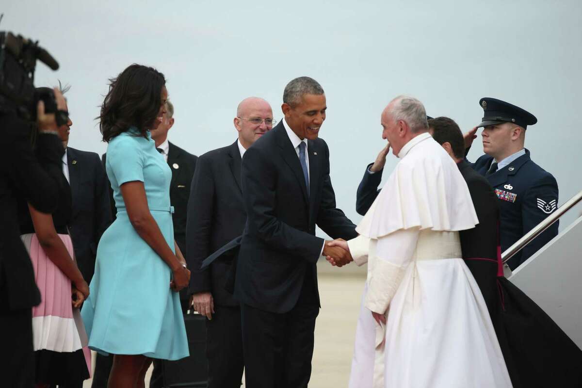 President Barack Obama and first lady Michelle Obama greet Pope Francis upon his arrival at Andrews Air Force Base, Md., Tuesday, Sept. 22, 2015.