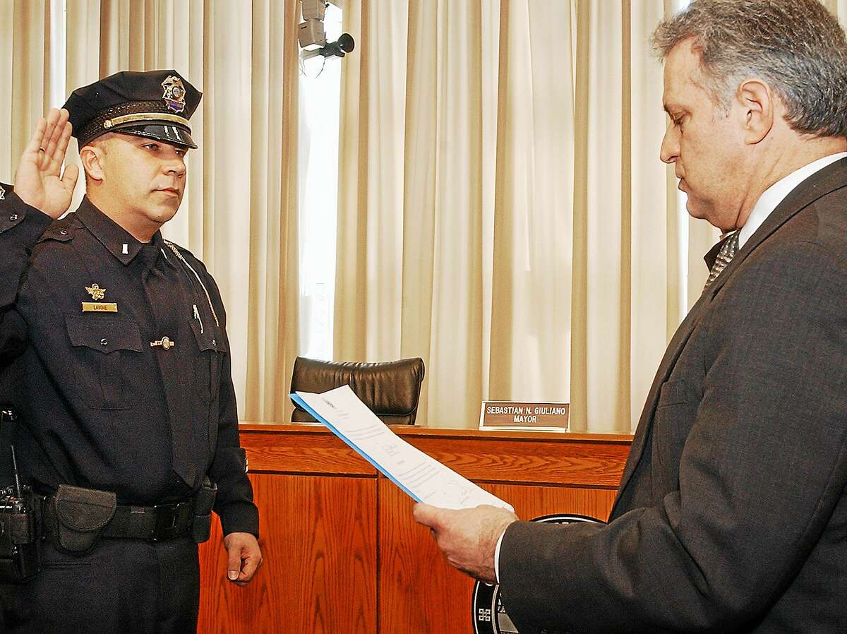 In this photo from January 2010, Middletown Police Lt. Christoper Lavoie is promoted by former Mayor Sebastian N. Giuliano to sergeant at a swearing-in ceremony at city hall.