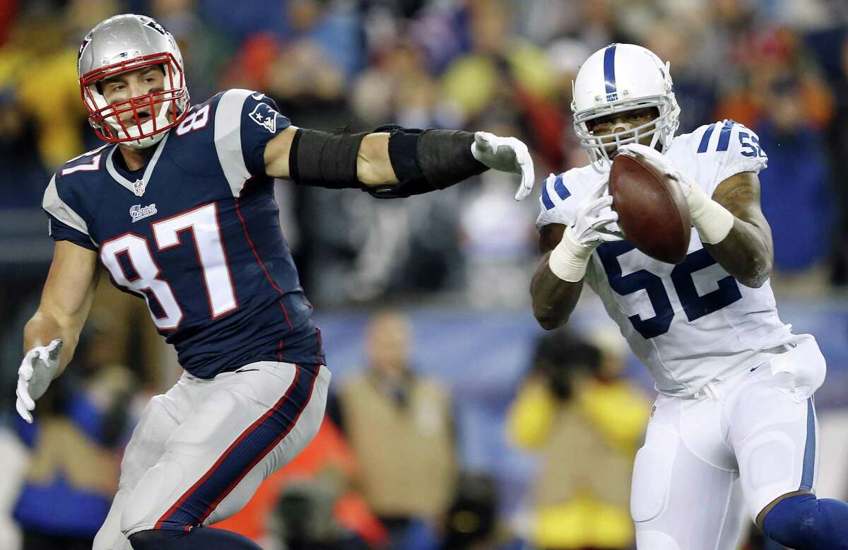 FILE - In this Sunday, Jan. 18, 2015, file photo, Indianapolis Colts inside linebacker D'Qwell Jackson (52) intercepts a pass intended for New England Patriots tight end Rob Gronkowski during the first half of the AFC championship NFL football game in Foxborough, Mass. The NFL is investigating whether the Patriots deflated footballs that were used in their AFC championship game victory over Colts.
