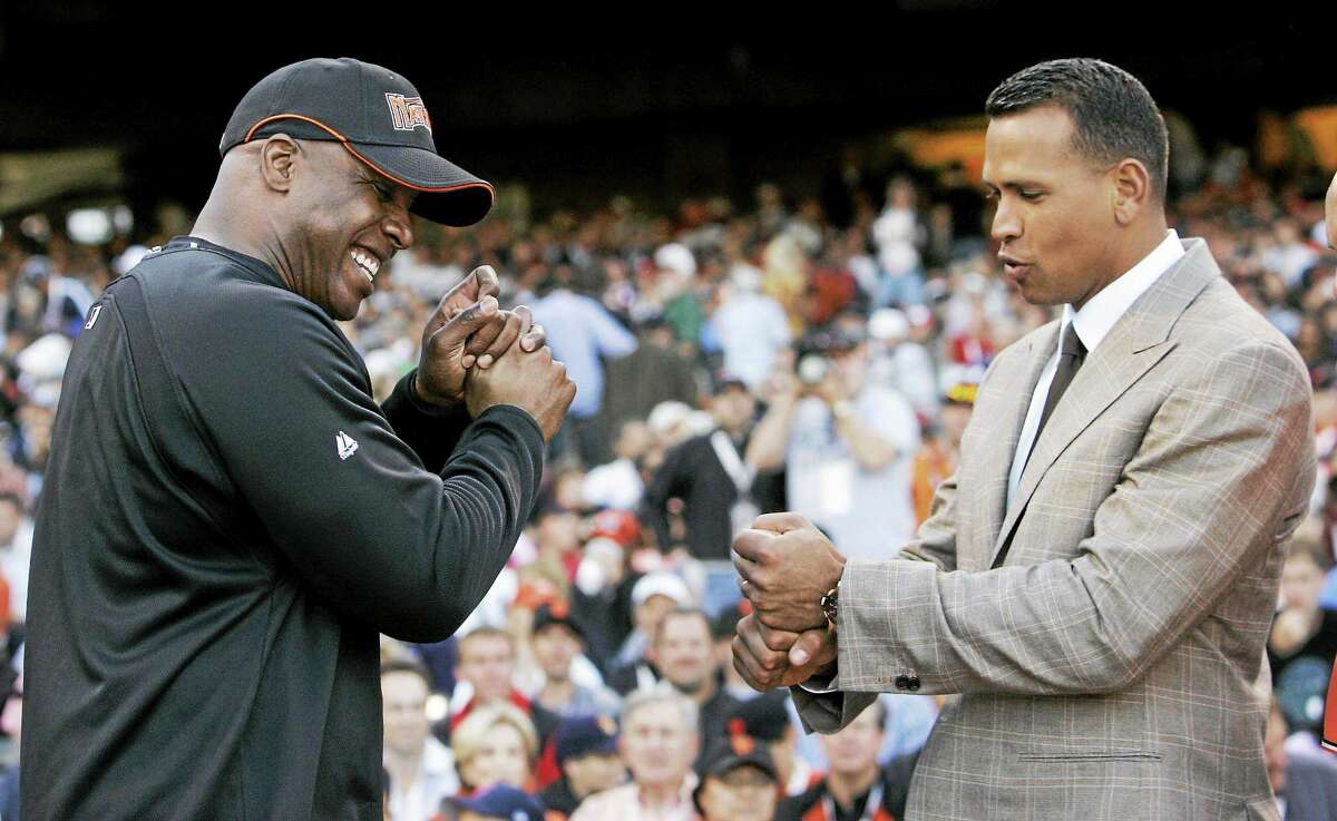 Alex Rodriguez, right, compares grips with Barry Bonds during the home run derby on July 9, 2007 in San Francisco.