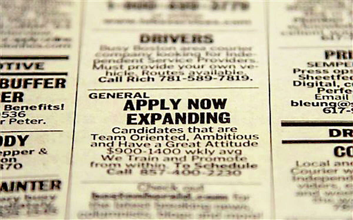 In this Tuesday, Dec. 11, 2012 photo taken in Walpole, Mass., an advertisement in the classified section of the Boston Herald newspaper calls attention to possible employment opportunities. The number of Americans seeking unemployment benefits fell sharply for a fourth straight week, a sign that the job market may be improving. The Labor Department said Thursday, Dec. 13, 2012, that weekly applications for unemployment benefits fell 29,000 last week to a seasonally adjusted 343,000, the lowest in two months. It is the second-lowest total this year. (AP Photo/Steven Senne)