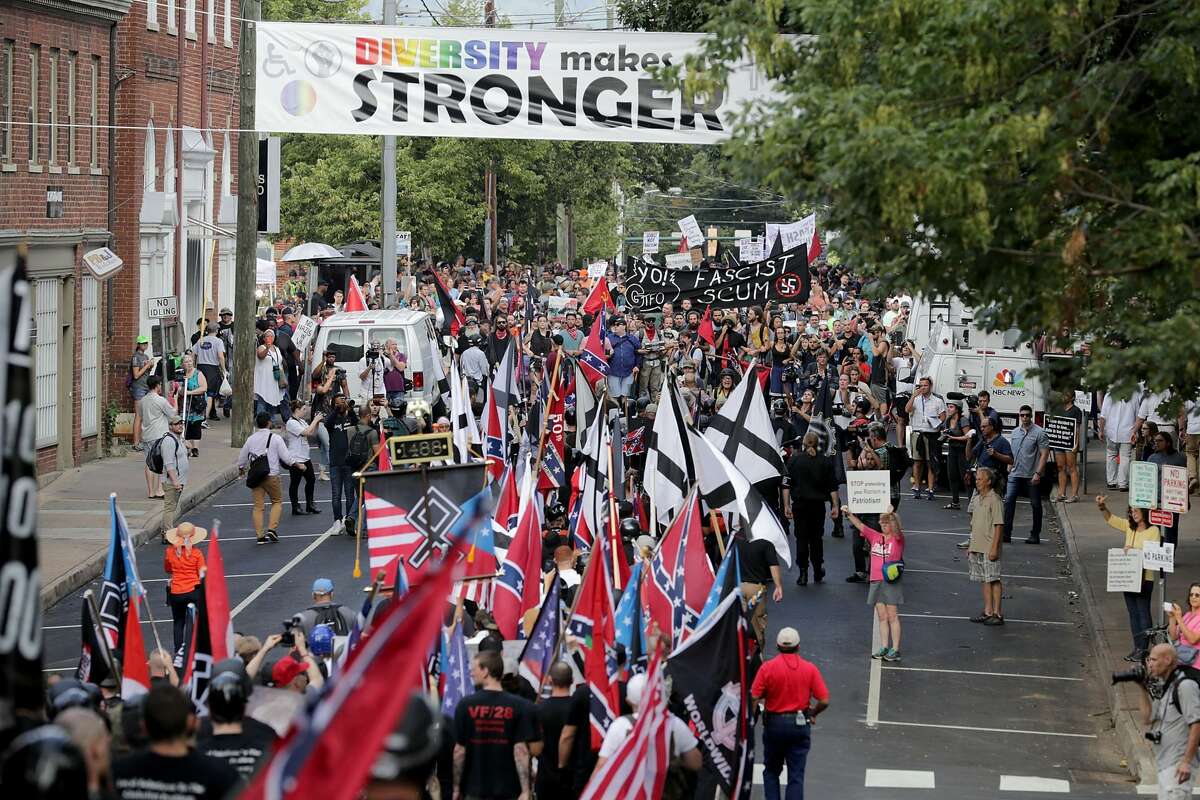 Hundreds of white nationalists, neo-Nazis and members of the "alt-right" march down East Market Street toward Lee Park during the "Unite the Right" rally August 12, 2017 in Charlottesville, Virginia. After clashes with anti-fascist protesters and police the rally was declared an unlawful gathering and people were forced out of Lee Park, where a statue of Confederate General Robert E. Lee is slated to be removed. (Photo by Chip Somodevilla/Getty Images)