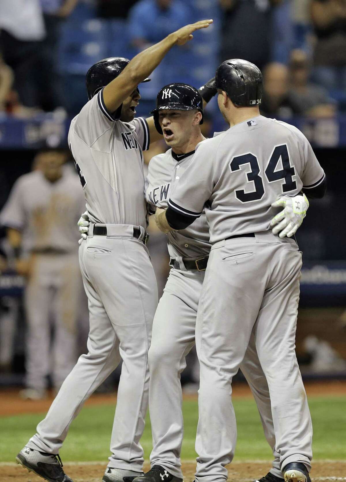 The Yankees’ Slade Heathcott, center, celebrates his three-run home run in the ninth inning on Monday.