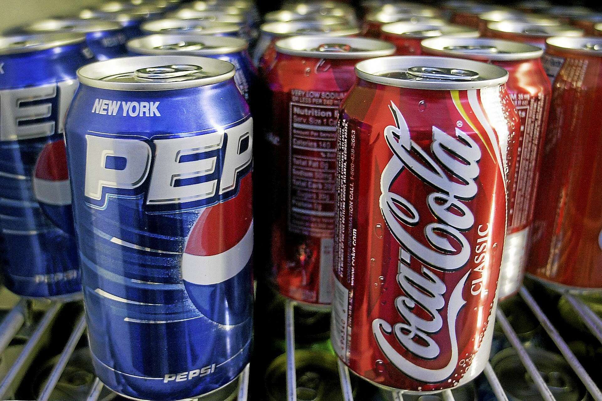 Could tiny Coke, Pepsi cans yield big profits for soda makers