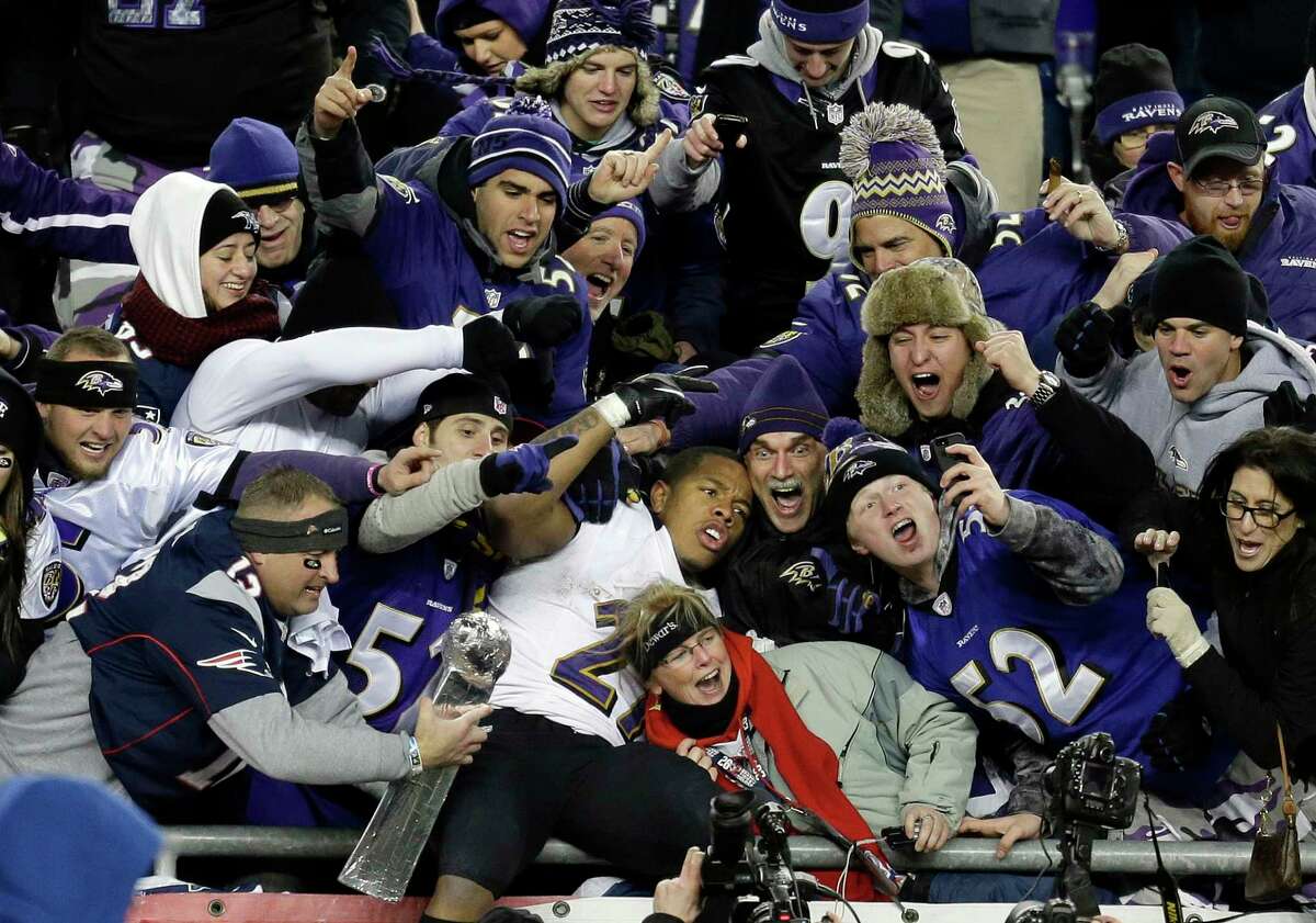 In this Jan. 20, 2013, file photo, Baltimore Ravens running back Ray Rice is surrounded by fans in the stands as he celebrates winning the AFC championship game against the New England Patriots in Foxborough, Mass.
