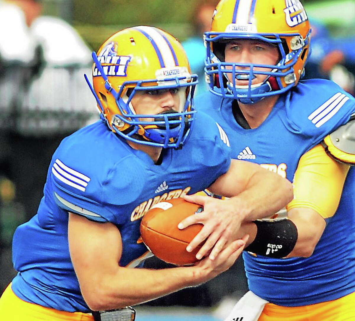 New Haven running back Mike DeCaro takes the handoff from Chargers quarterback Ronnie Nelson during the Chargers’ Oct. 19, 2013, game against Stonehill.