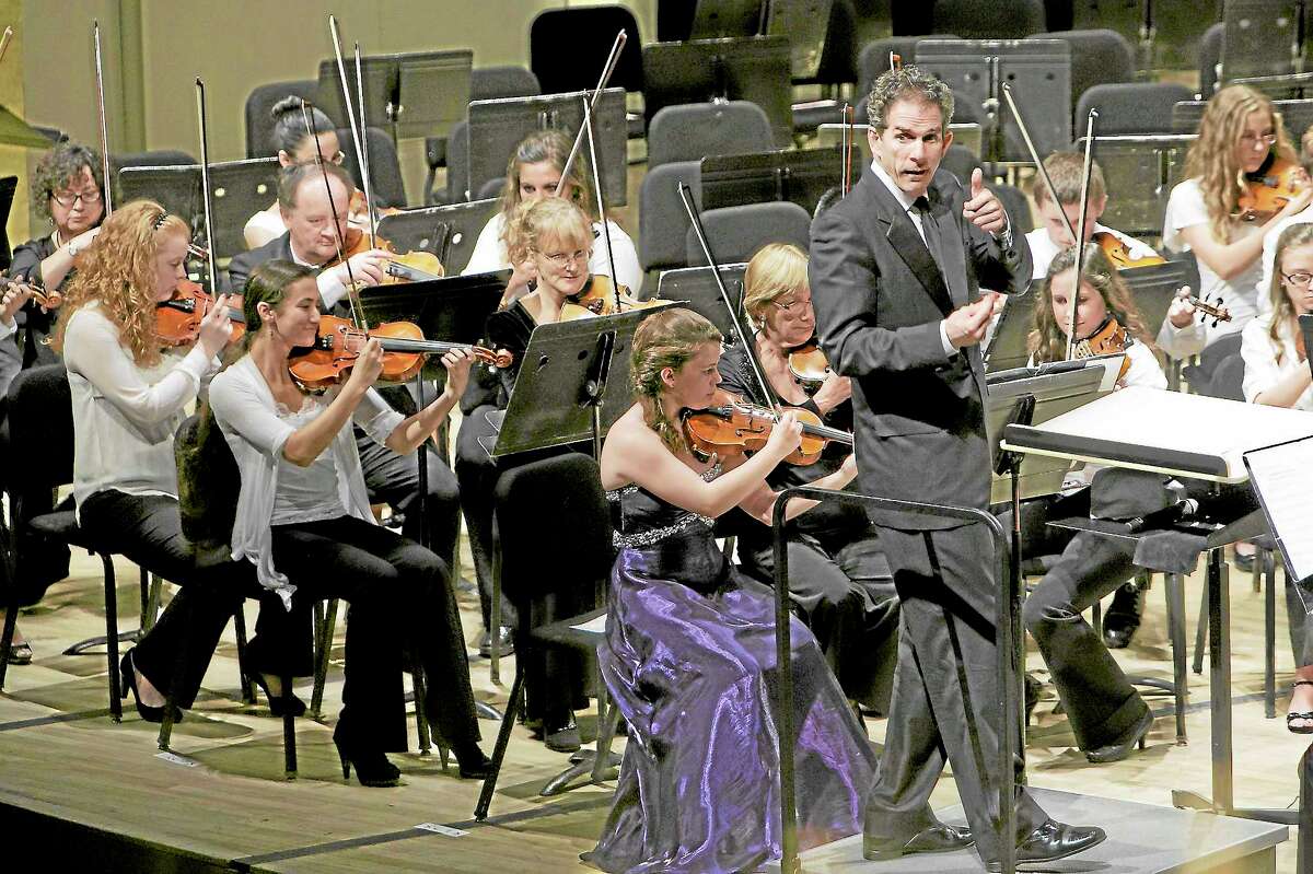 Conductor Edward Cumming gives a thumbs up for the audience participation during the strings performance of Middletown High Goes to the Symphony in this file photo.