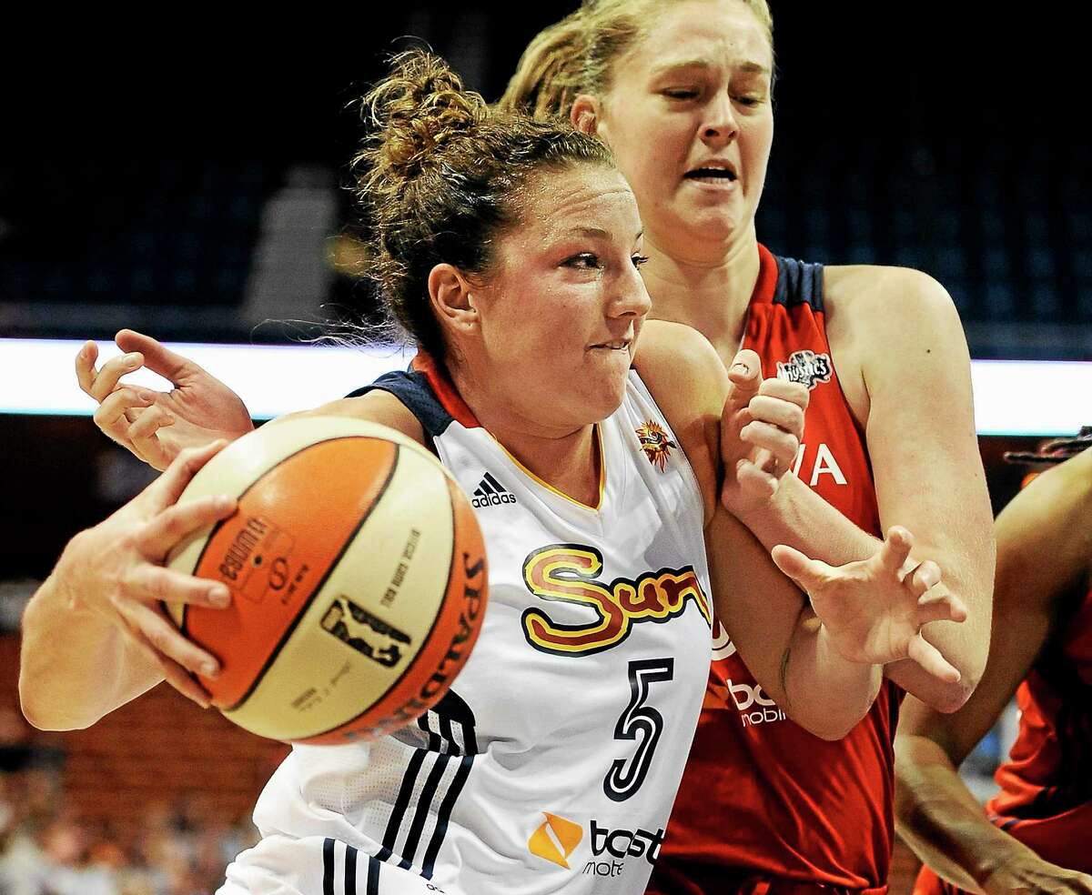The Connecticut Sun’s Kelsey Griffin drives to the basket as the Washington Mystics’ Emma Meesseman defends during a 2013 game in Uncasville.