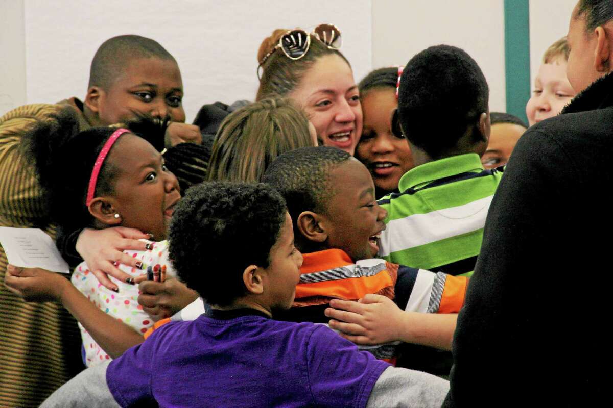 Screams of excitement erupt at Lawrence Elementary School as a group of students hugged DATTCO bus driver Wendy Valero.