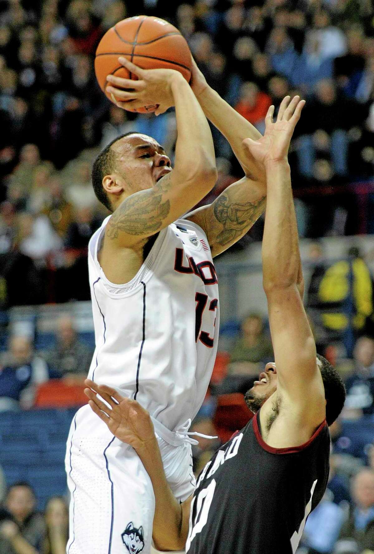 UConn’s Shabazz Napier (13) shoots over Harvard’s Brandyn Curry on Wednesday.