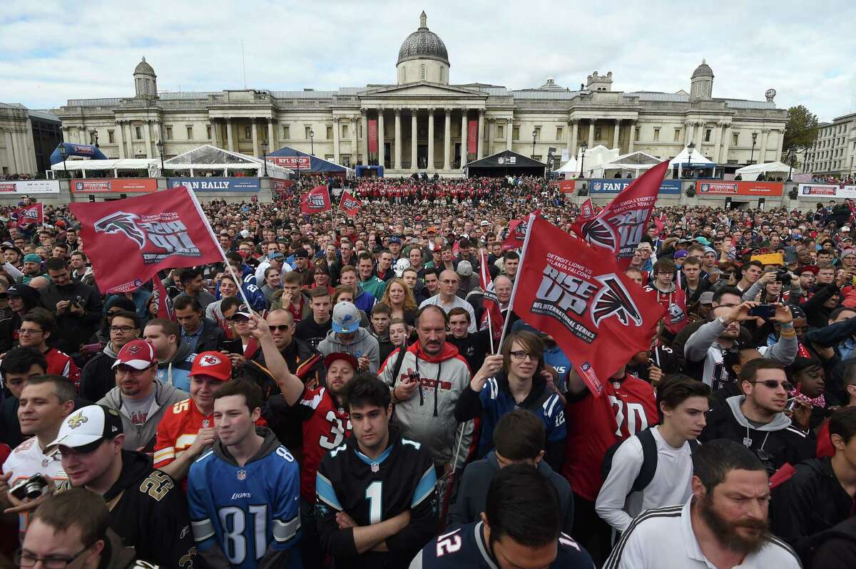 Football fans wave flags during the NFL Fan Rally on Saturday in Trafalgar Square in London. The National Gallery of art is in the background. The Atlanta Falcons will play the Detroit Lions on Sunday at Wembley Stadium in a contest which will be broadcast live on the East Coast at 9:30 a.m. Register sports columnist Chip Malafronte believes the Sunday morning NFL game should become a weekly happening.