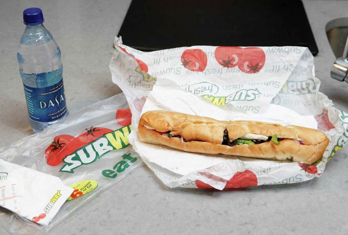 This file photo, shows a chicken breast sandwich and water from Subway on a kitchen counter in New York.