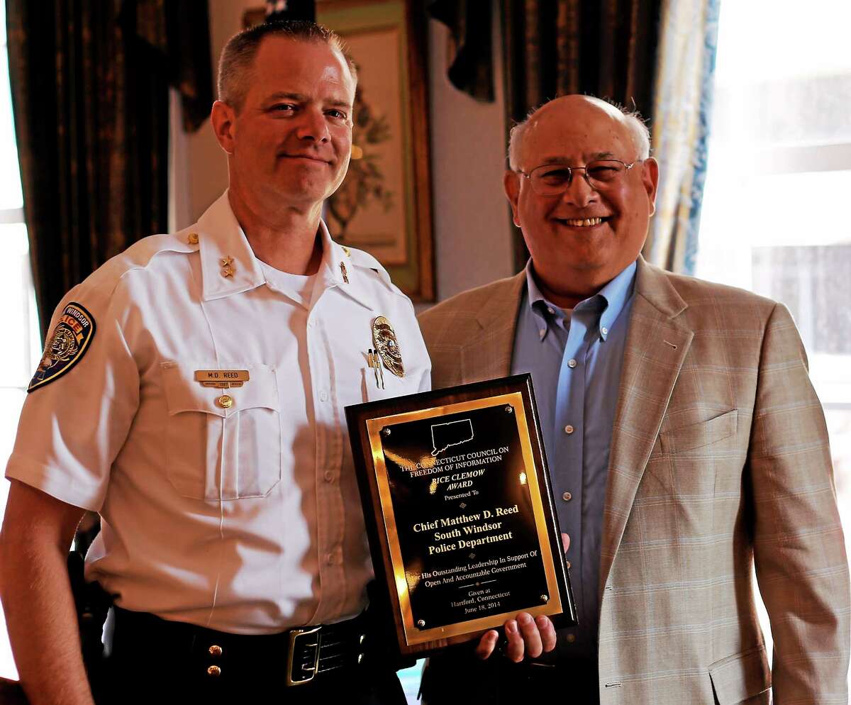 South Windsor Police Chief Matthew Reed, left, accepts the Bice Clemow Award from the Connecticut Council on Freedom of Information at The Hartford Club Wednesday. He is seen here with Mitch Pearlman.