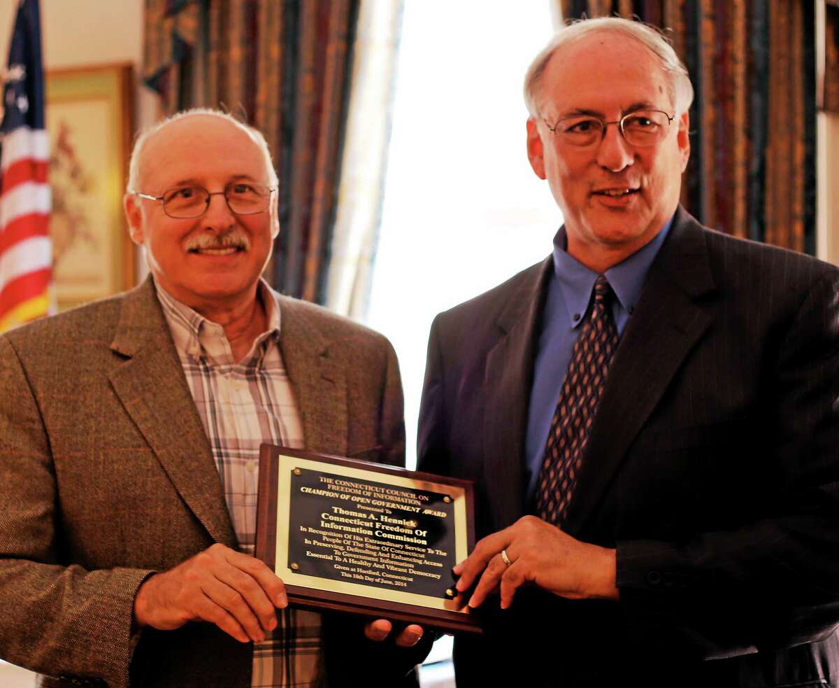 Thomas Hennick, left, of the Connecticut Freedom of Information Commission accepted an Champion of Open Government award from the Connecticut Council on Freedom of Information Wednesday in Hartford.