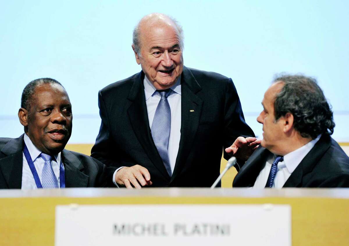 FIFA President Sepp Blatter, center, and UEFA President Michel Platini, right, have been banned for 90 days.