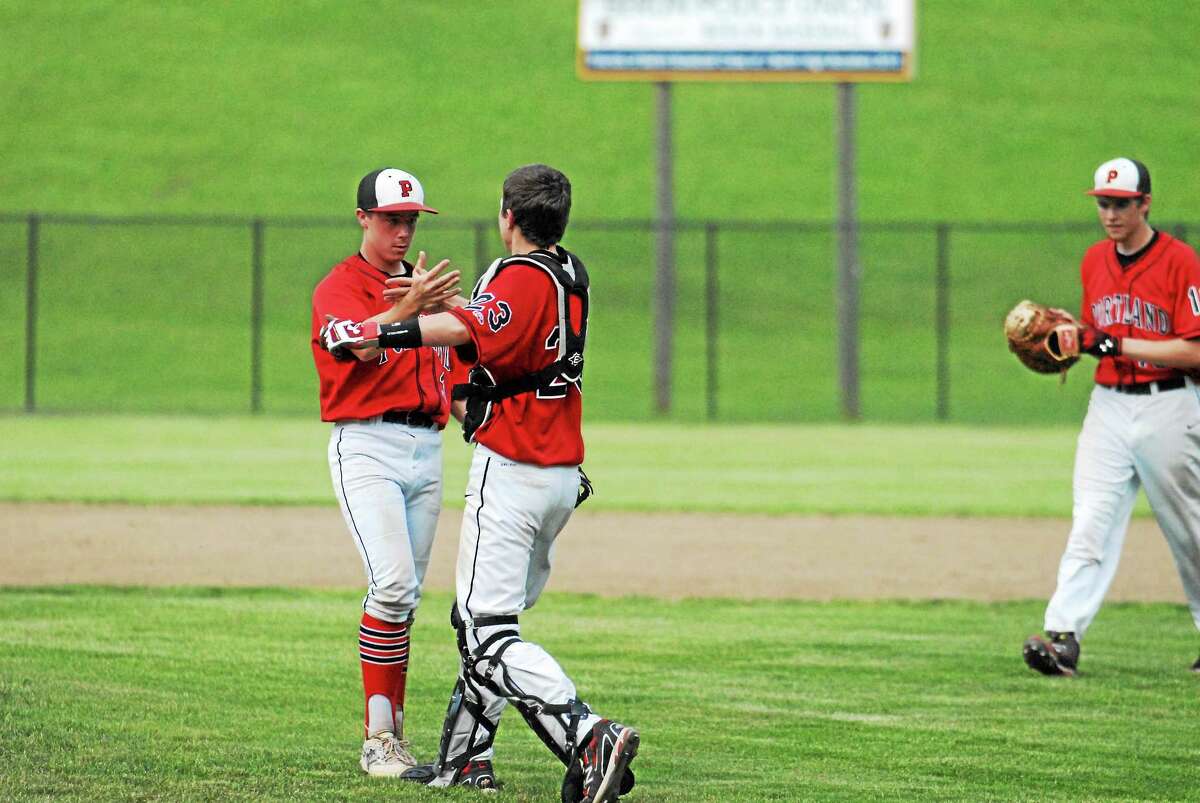 Portland freshman catcher Roland Thivierge congratulates pitcher Cole Ogorzalek after the final out in the Class S semifinals at Sage Park in Berlin.
