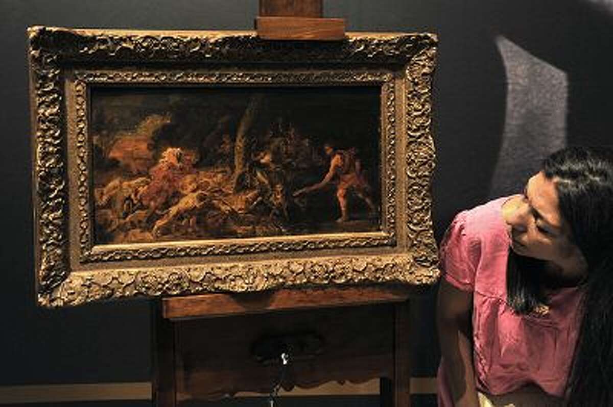 An employee presents the stolen 17th-century oil sketch "The Calydonian Boar Hunt" attributed to the Flemish master, Peter Paul Rubens' workshop, during its presentation at the national gallery in Athens on September 8, 2011. The painting was snatched in 2001 from the Fine Arts Museum of Ghent in Belgium and recovered in Greece a week ago during an police operation. AFP PHOTO / LOUISA GOULIAMAKI (Photo credit should read LOUISA GOULIAMAKI/AFP/Getty Images)